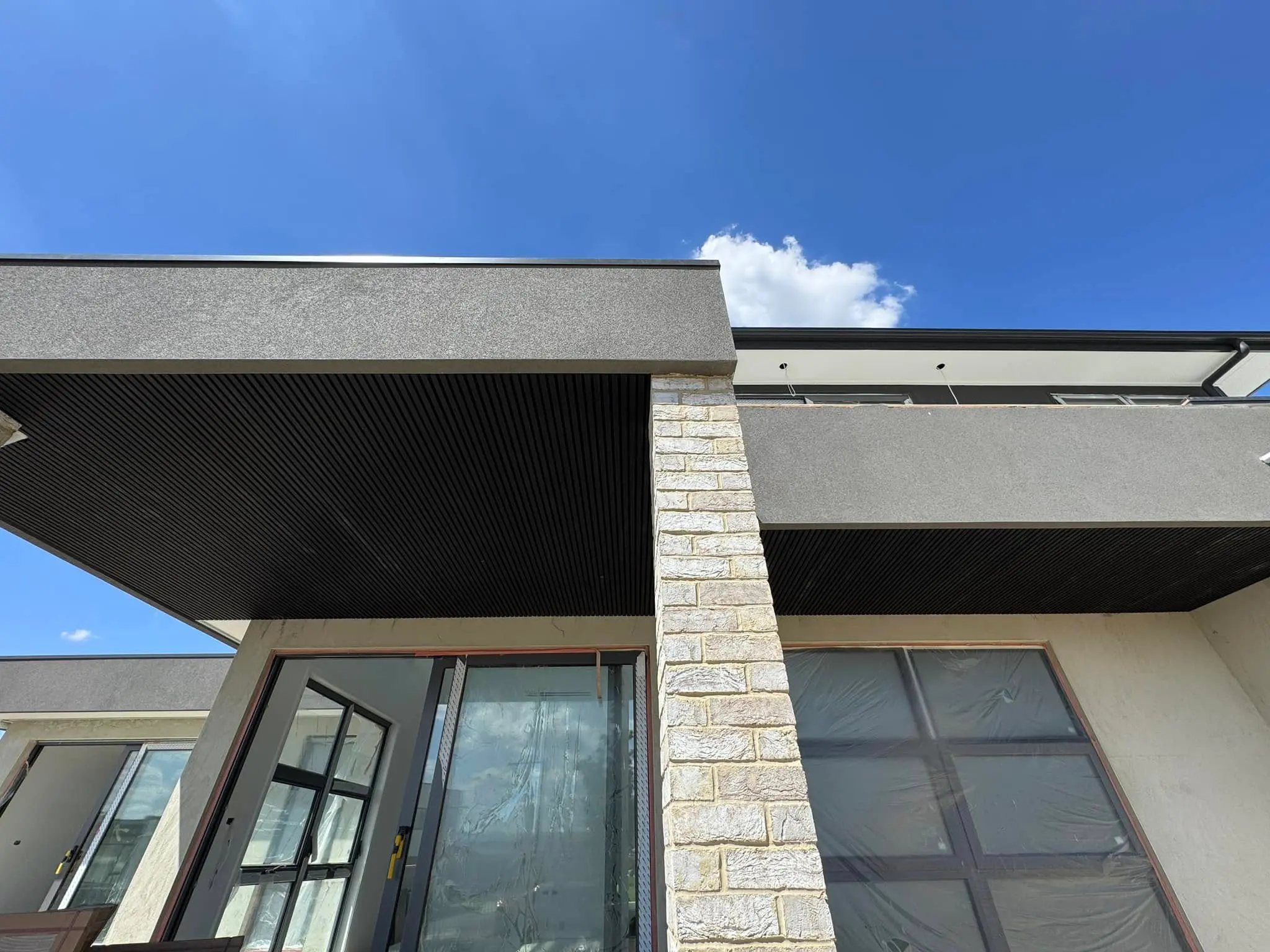 Corner view of black batten soffit finish