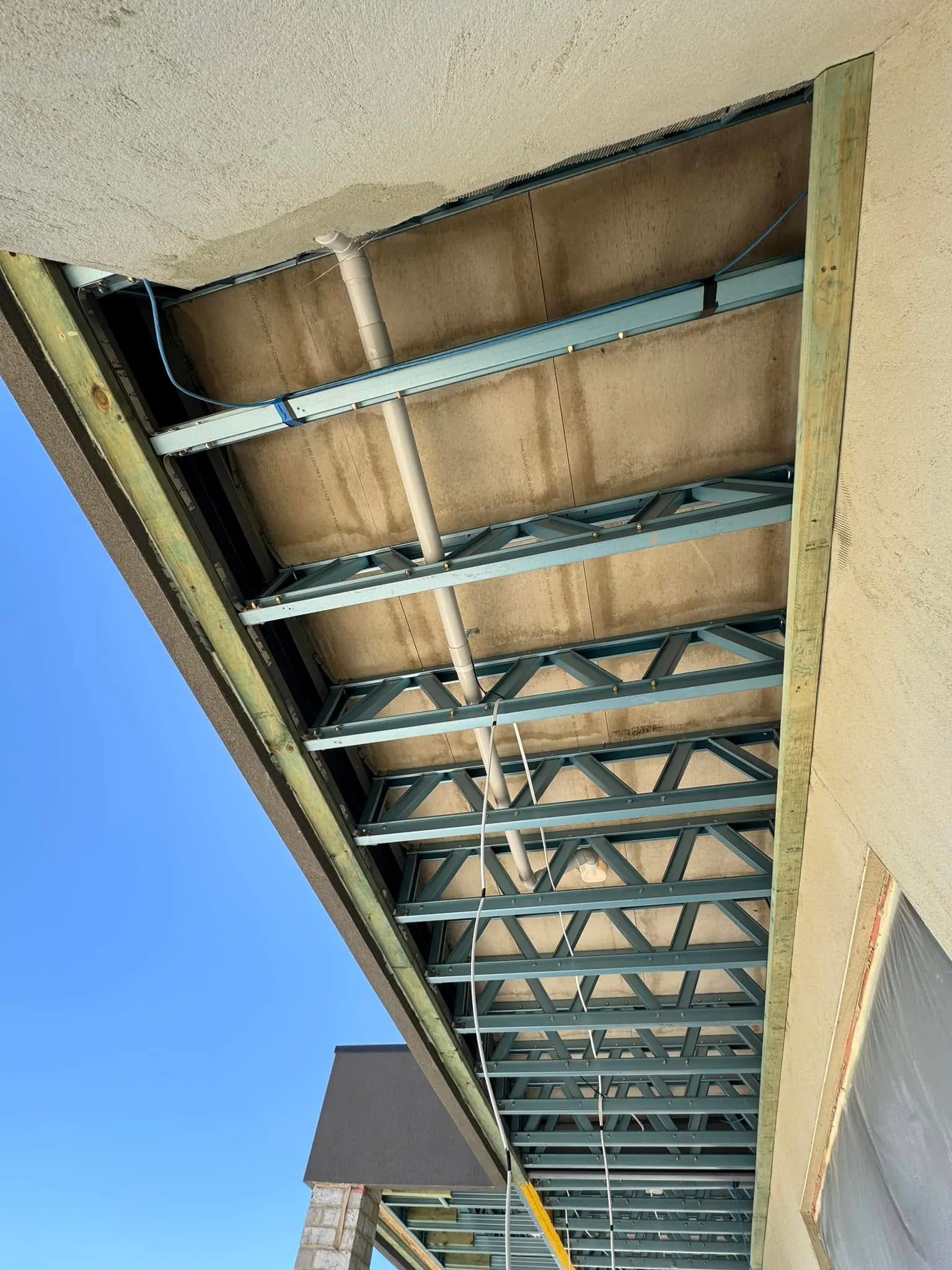 Steel eave frame before black batten cladding