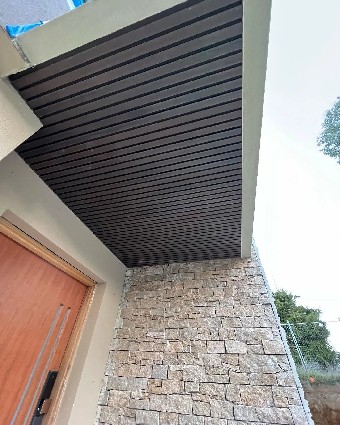 Timber-look slat ceiling eave soffit after transformation
