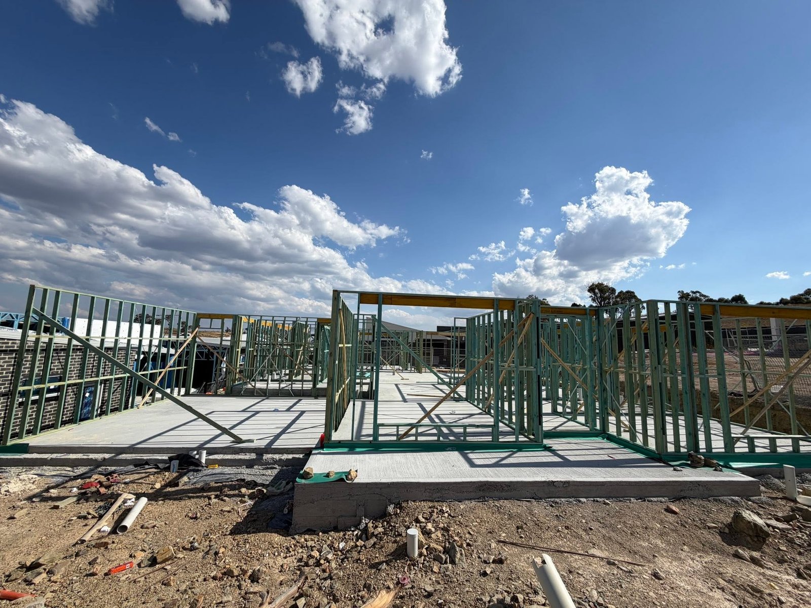 Wall framing on site under cloudy sky